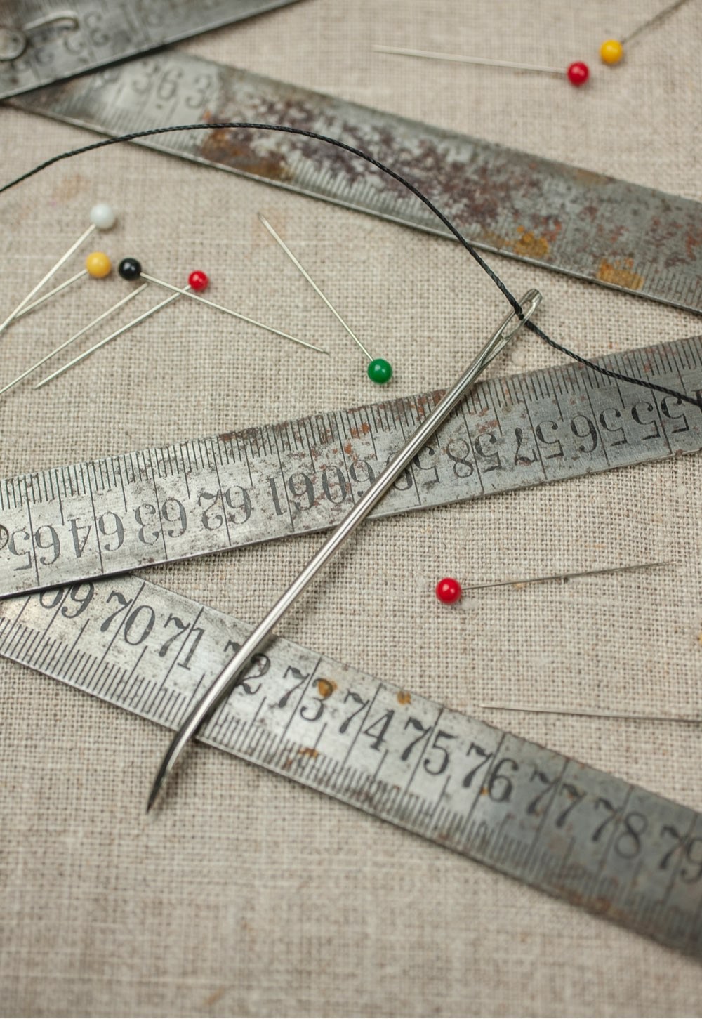 A vintage measuring stick and needles at the studio