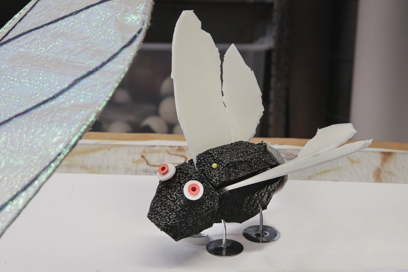 Foam fly with metal feet and orange eyes