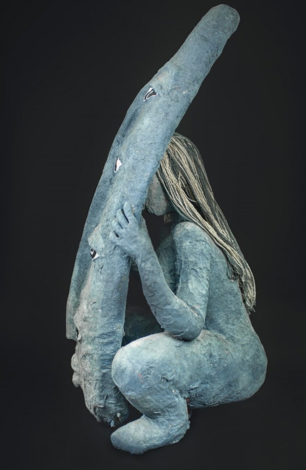 Profile, a grey female figure hiding behind grey shield with four pairs of eyes