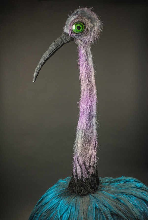 A half portrait of Claudia the lilac and turquoise ostrich